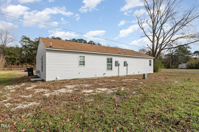 rear view of property featuring a lawn