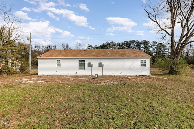 back of property featuring a yard