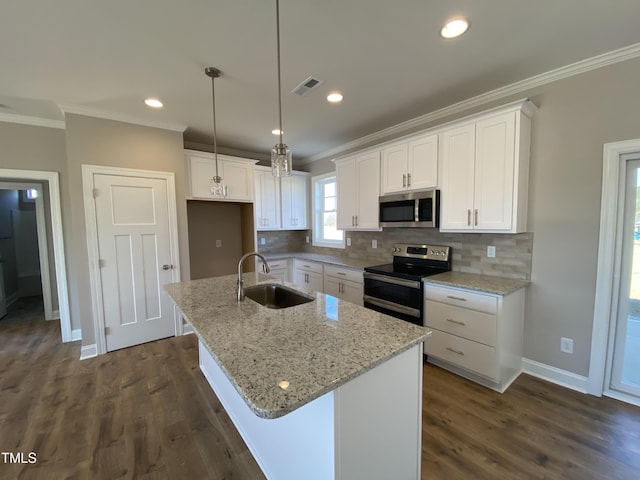 kitchen with visible vents, ornamental molding, stainless steel appliances, white cabinetry, and a sink