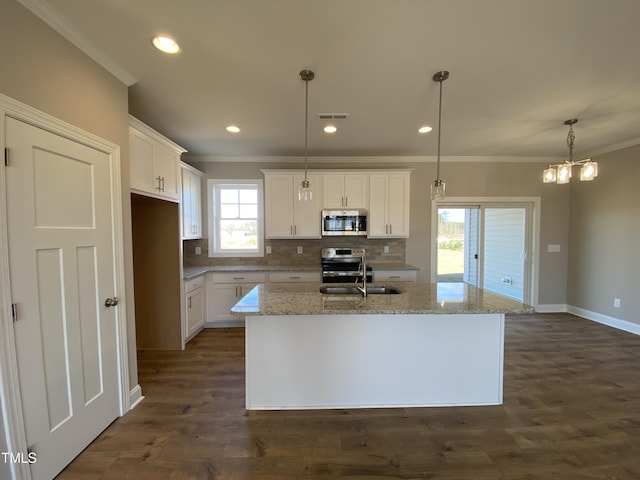 kitchen featuring visible vents, ornamental molding, appliances with stainless steel finishes, and decorative backsplash
