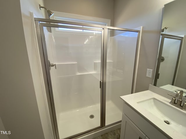 bathroom featuring a shower stall and vanity