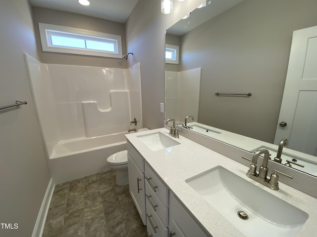 full bathroom featuring toilet, a sink, double vanity, and shower / washtub combination