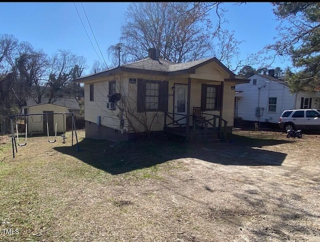 view of front of home with an outbuilding and a storage shed