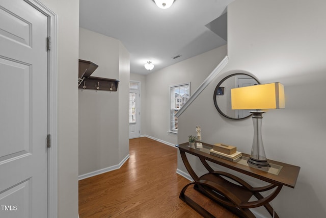 corridor with hardwood / wood-style floors