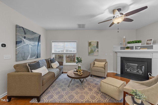 living room featuring wood-type flooring and ceiling fan