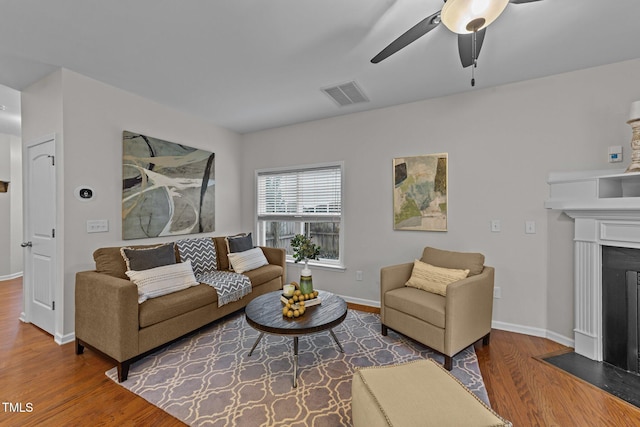 living room featuring hardwood / wood-style floors and ceiling fan