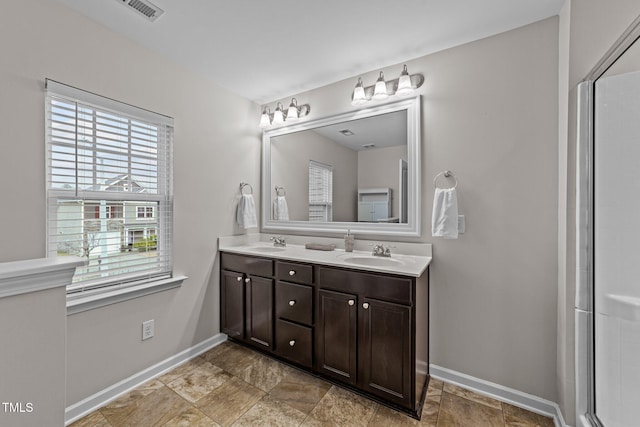 bathroom with vanity and a shower with shower door