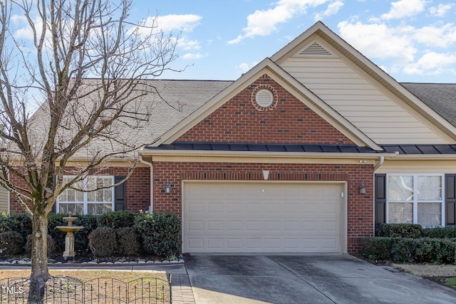 traditional-style home with a standing seam roof, brick siding, metal roof, and concrete driveway