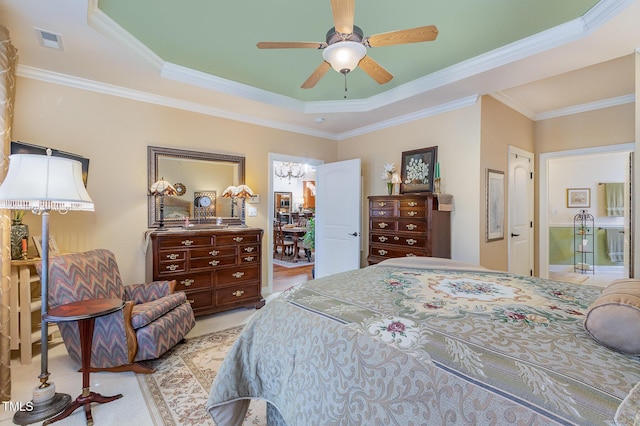 bedroom featuring ornamental molding, visible vents, a ceiling fan, and a tray ceiling