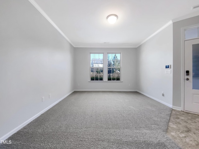 carpeted empty room featuring crown molding