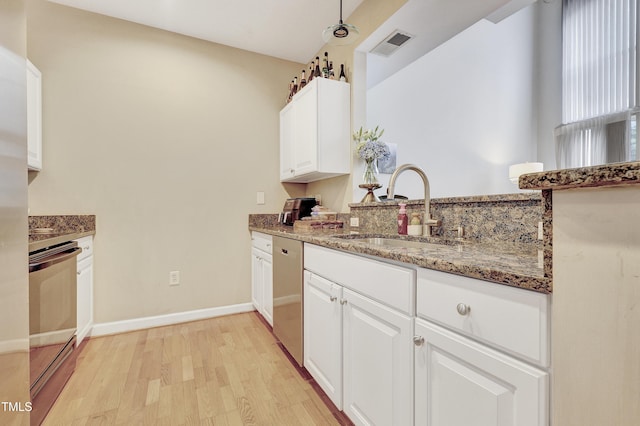 kitchen featuring sink, white cabinetry, light hardwood / wood-style flooring, electric range oven, and stone counters