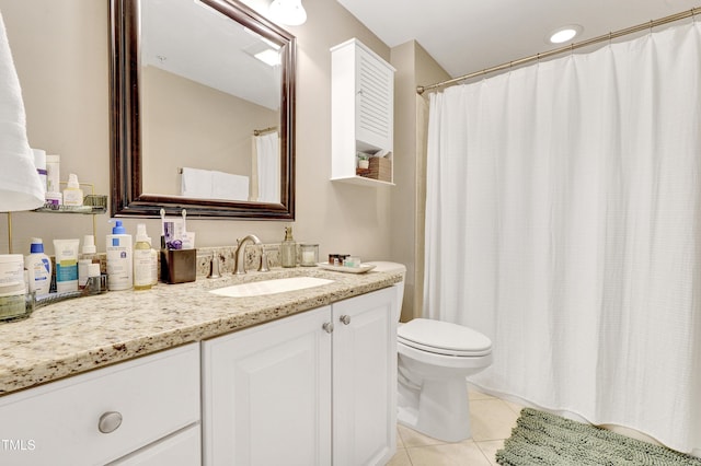 bathroom with tile patterned flooring, vanity, and toilet