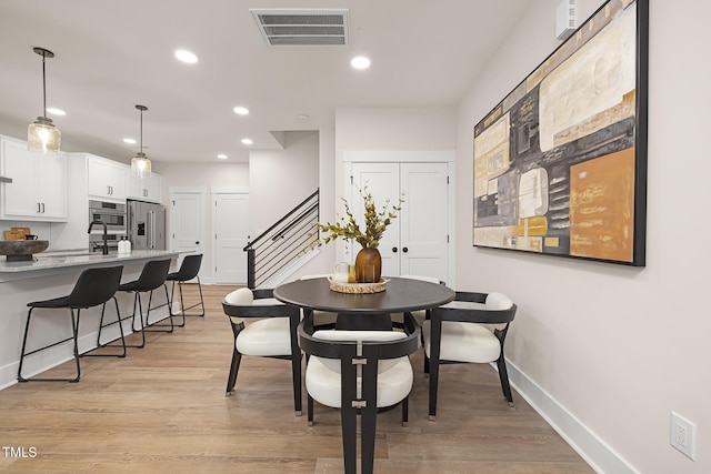 dining area with light hardwood / wood-style flooring