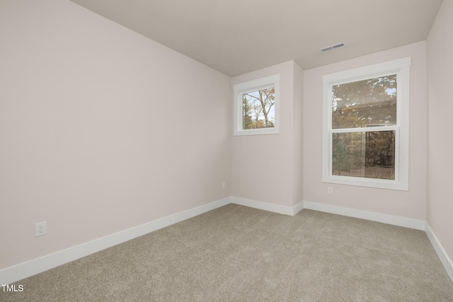 unfurnished room featuring light colored carpet