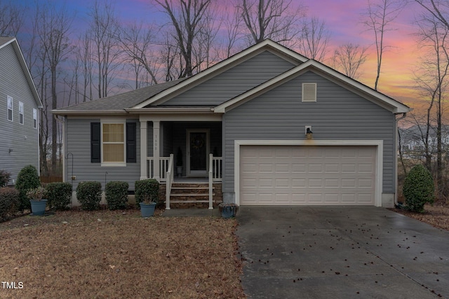 ranch-style home with a garage, covered porch, and driveway