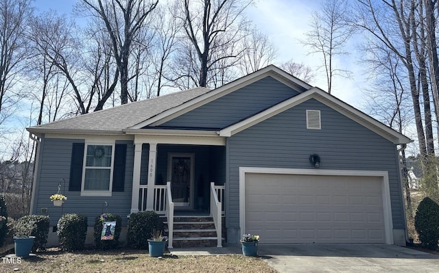 view of front facade with a garage, driveway, a porch, and a shingled roof