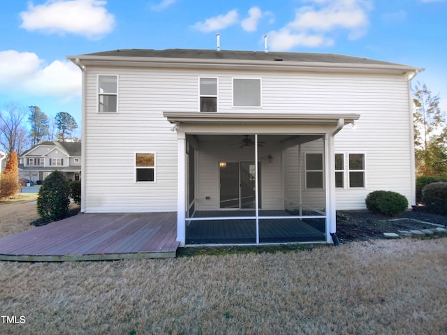 rear view of property featuring a wooden deck, ceiling fan, and a sunroom