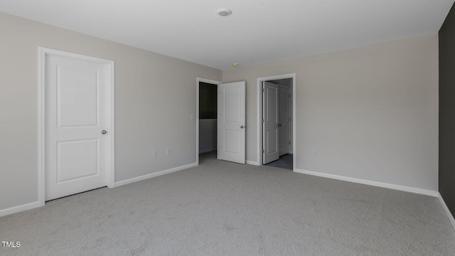 unfurnished bedroom with light colored carpet