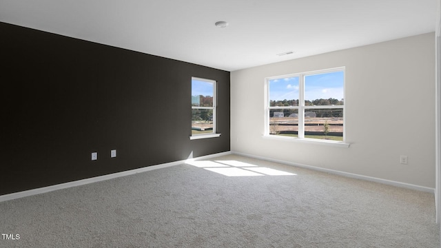 spare room featuring light colored carpet