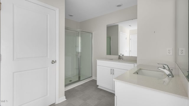 bathroom featuring vanity and an enclosed shower