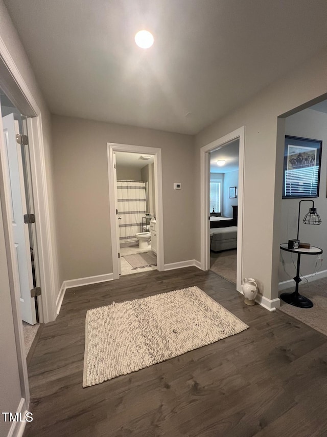 hallway with dark hardwood / wood-style floors