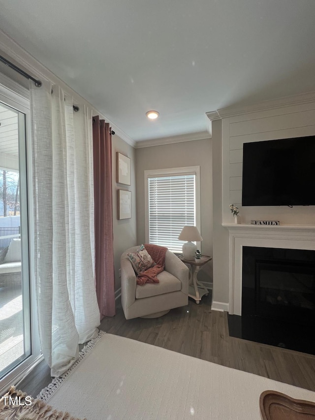 living room with dark wood-type flooring and ornamental molding