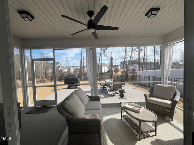 sunroom featuring ceiling fan and a healthy amount of sunlight