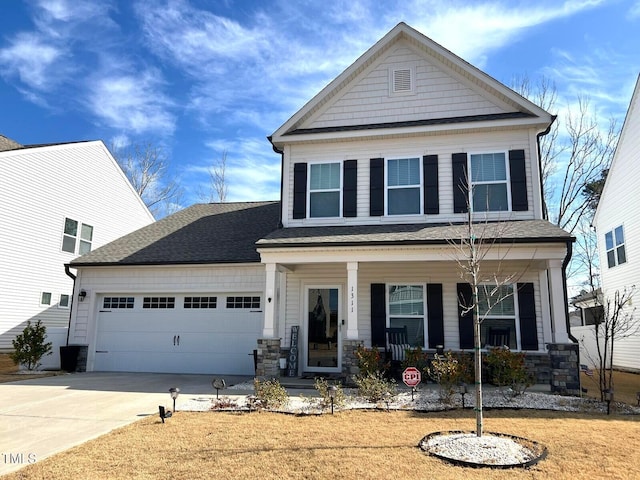 view of front facade with a porch, a garage, and a front yard