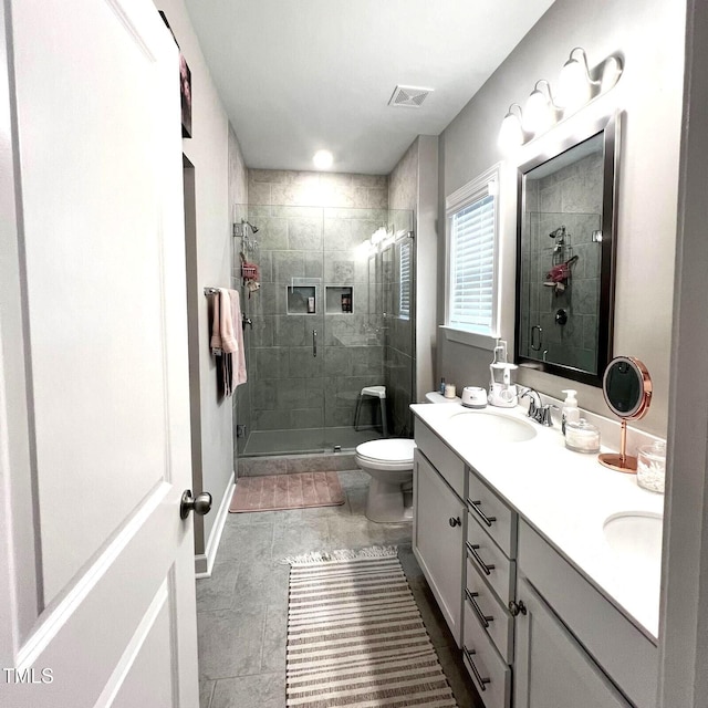 bathroom with vanity, toilet, and walk in shower