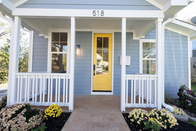 view of exterior entry with a porch