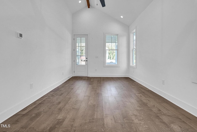 unfurnished living room featuring hardwood / wood-style flooring, ceiling fan, high vaulted ceiling, and beamed ceiling