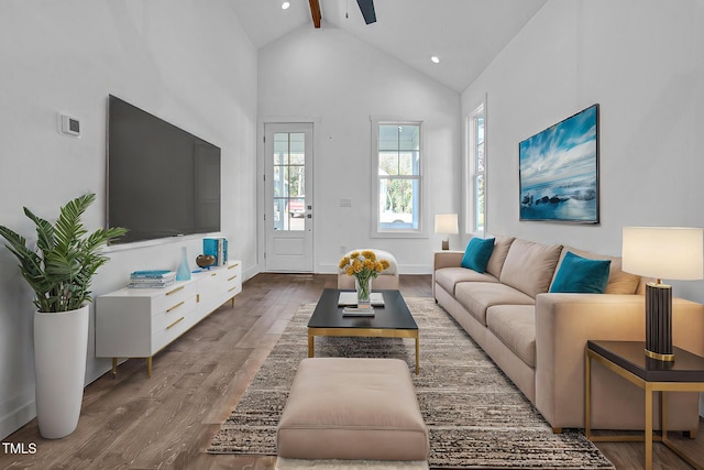 living room with beamed ceiling, ceiling fan, high vaulted ceiling, and hardwood / wood-style floors