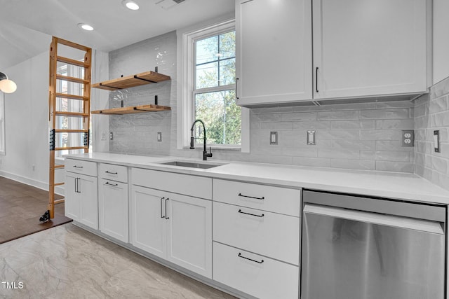 kitchen with sink, backsplash, stainless steel dishwasher, and white cabinets