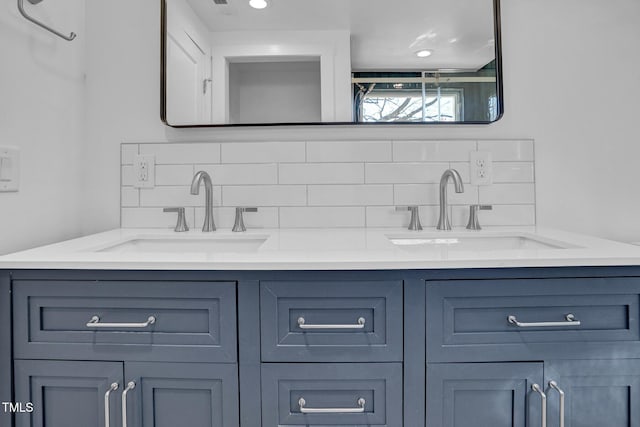 bathroom featuring vanity and tasteful backsplash