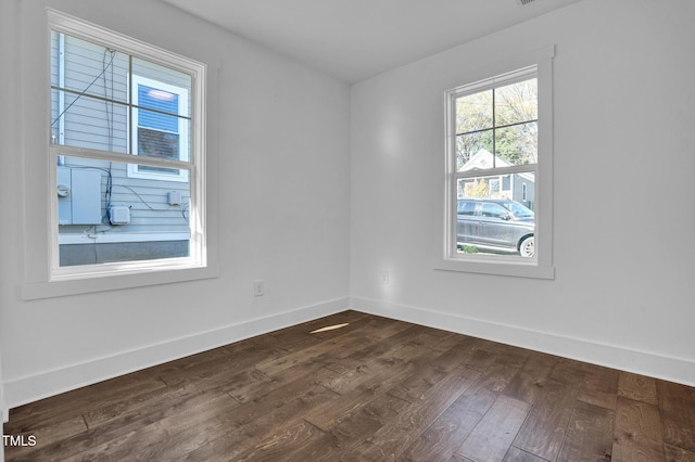 empty room with dark wood-type flooring