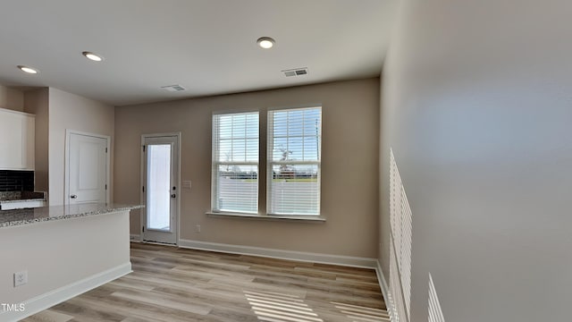 doorway to outside with light wood-type flooring