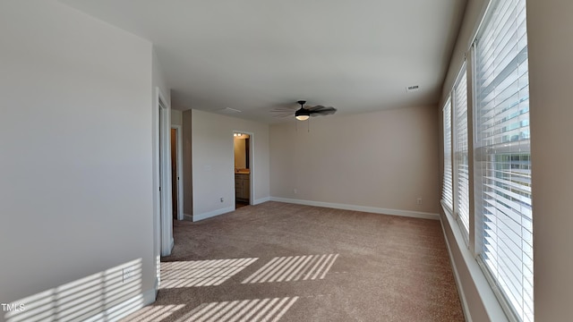 carpeted empty room featuring ceiling fan