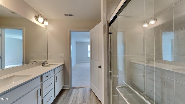 bathroom featuring vanity, a shower with door, and hardwood / wood-style floors