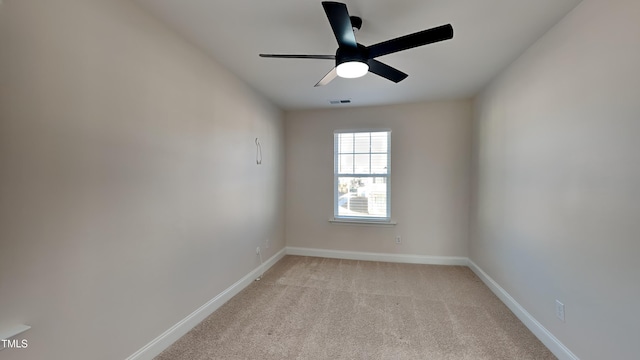 carpeted spare room with ceiling fan