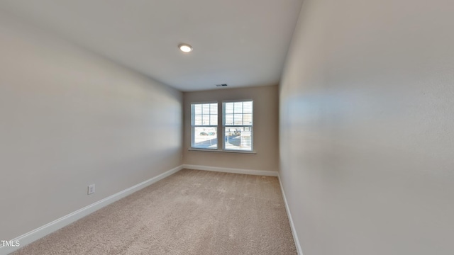 unfurnished room with light carpet