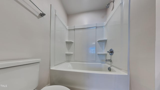 bathroom with bathing tub / shower combination and toilet