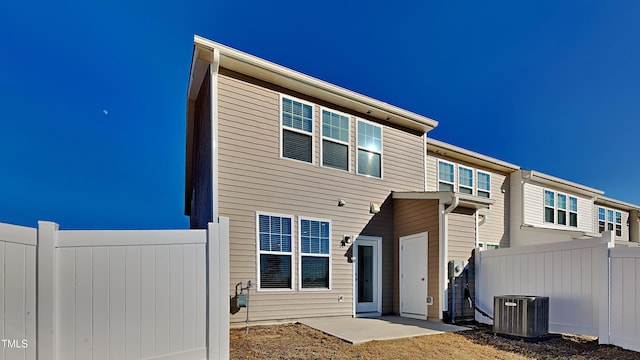 view of front of house with central AC unit and a patio area