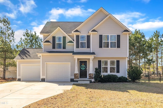 view of front of property with a garage and a front lawn