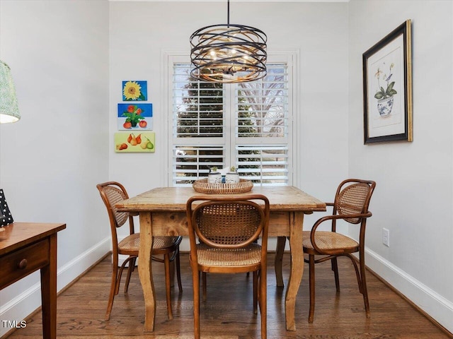 dining room featuring dark wood-type flooring and a notable chandelier