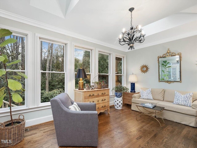 living room with dark wood-type flooring, plenty of natural light, and ornamental molding