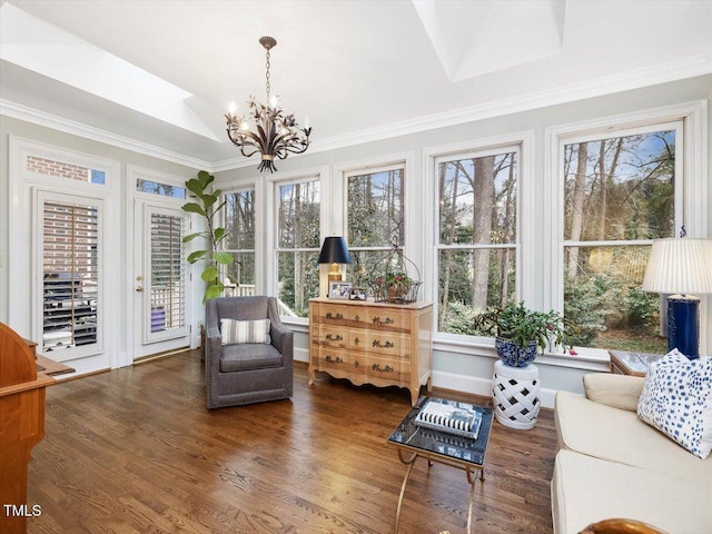 sunroom with an inviting chandelier and lofted ceiling