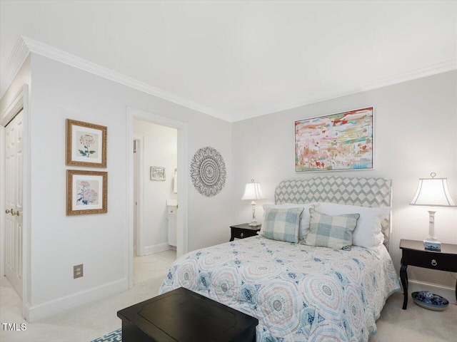 bedroom featuring ornamental molding, light colored carpet, and ensuite bathroom