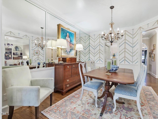 dining room featuring a notable chandelier, crown molding, and wood-type flooring