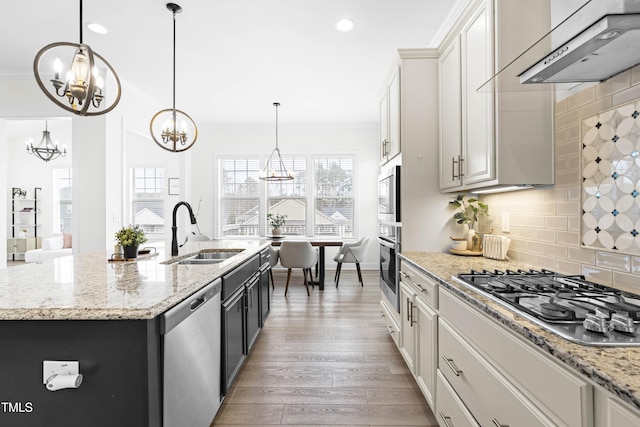 kitchen with a chandelier, stainless steel appliances, ventilation hood, and ornamental molding