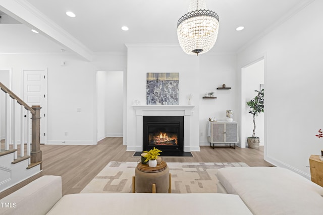 living area with wood finished floors, a fireplace with flush hearth, recessed lighting, stairs, and crown molding